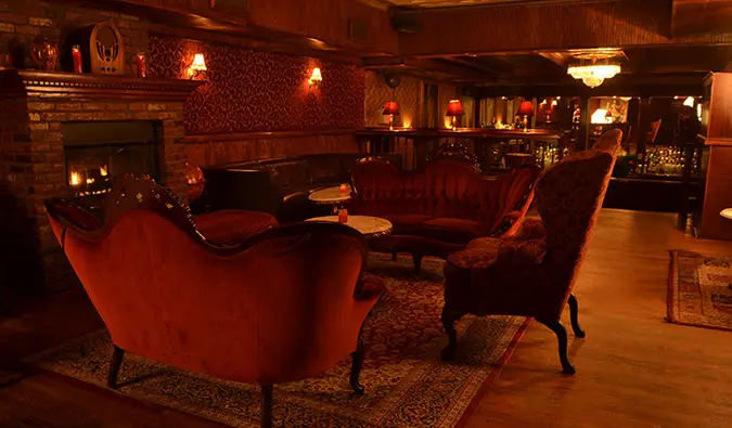 The Back Room has an elegant bar with a grand chandelier overhead, the perfect atmosphere for a prohibition bar