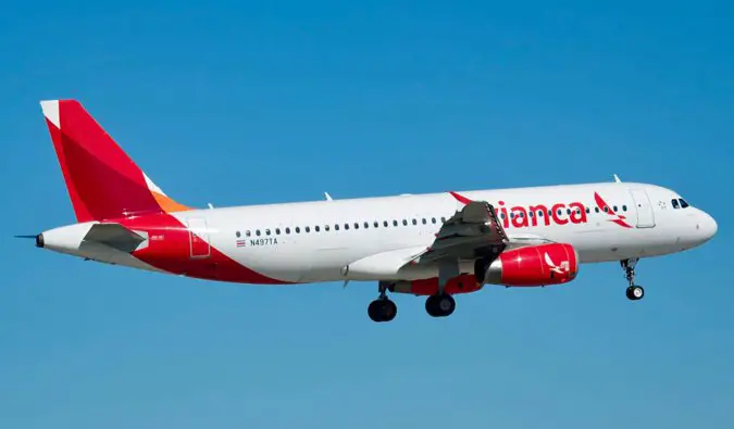 a Avianca flight taking off against a blue sky in Central America