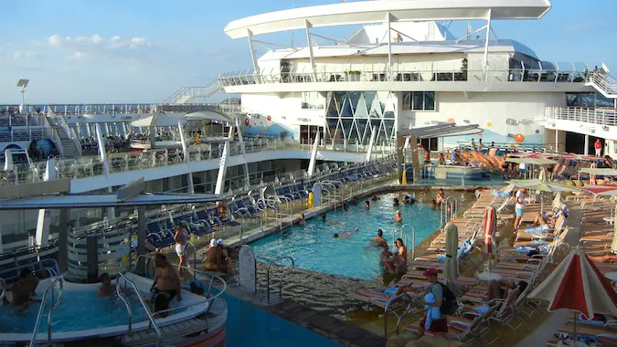 cruise deck filled with lots of passengers on vacation