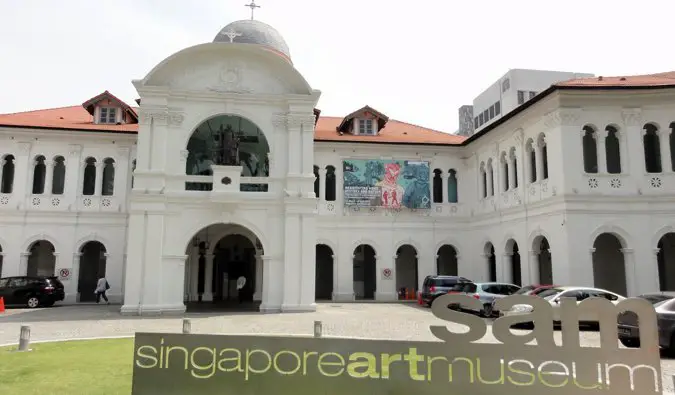 The facade and parking lot of the Singapore Art Museum in Singapore