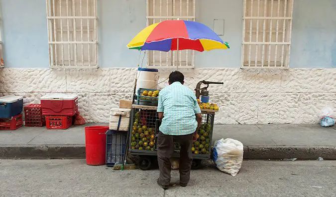 a street food vendor in Colombia selling fruit