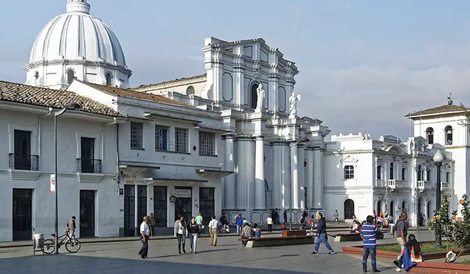 white buildings in Popayán with people walking around the main town plaza