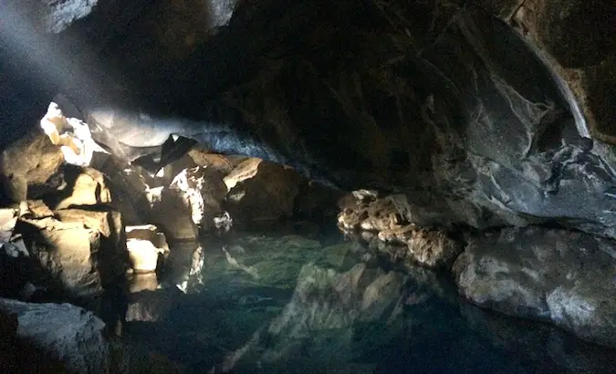 This water in the cave is warm enough to swim in and used to be a public pool for Iceland%image_alt%27s locals