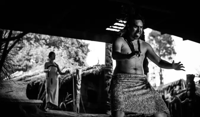 a black and white photo of a Maori warrior