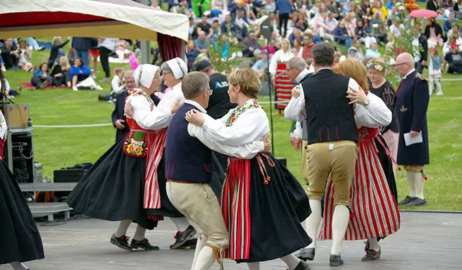 Swedes wearing traditional clothing celebrating Midsummer; Photo by Donald Judge (flickr:@donaldjudge)