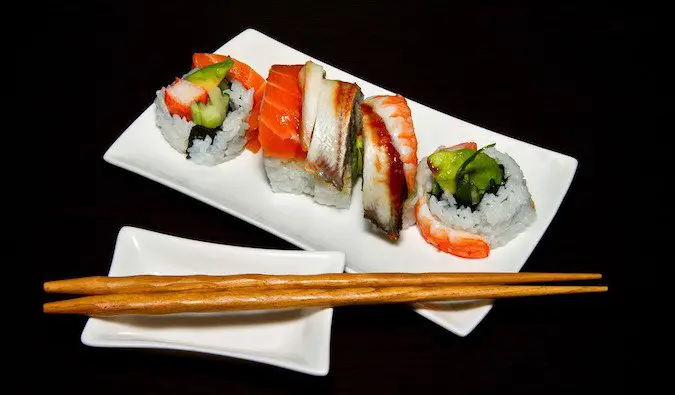 Beautiful colorful sushi and sashimi with chopsticks
