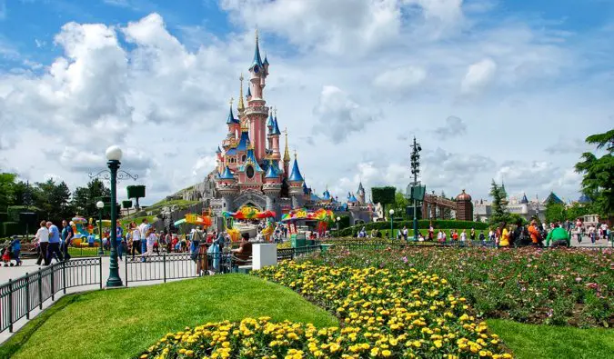 The picture-perfect castle at the heart of Disneyland Paris surrounded by flowers in France