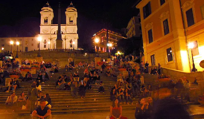 People sitting on stairs near the sidewalk bars in Rome