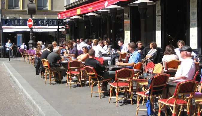 People dining at a street cafe in Paris France