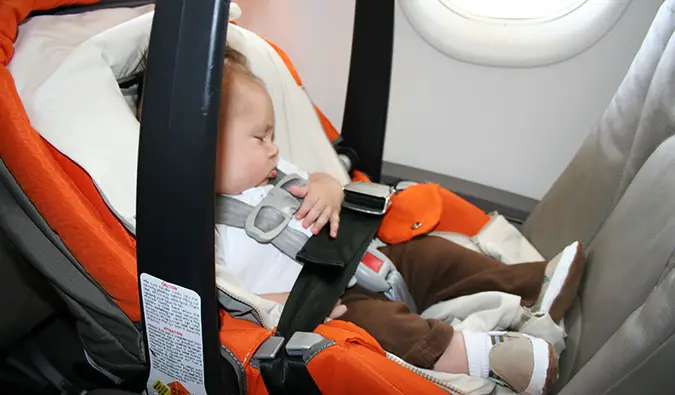 a baby sleeping on a plane