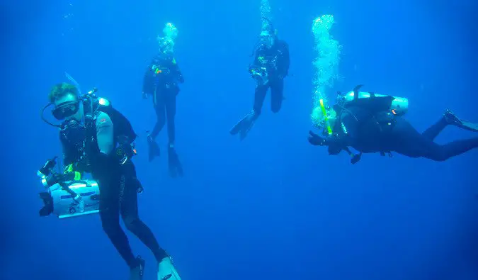 scuba instructor diving with group